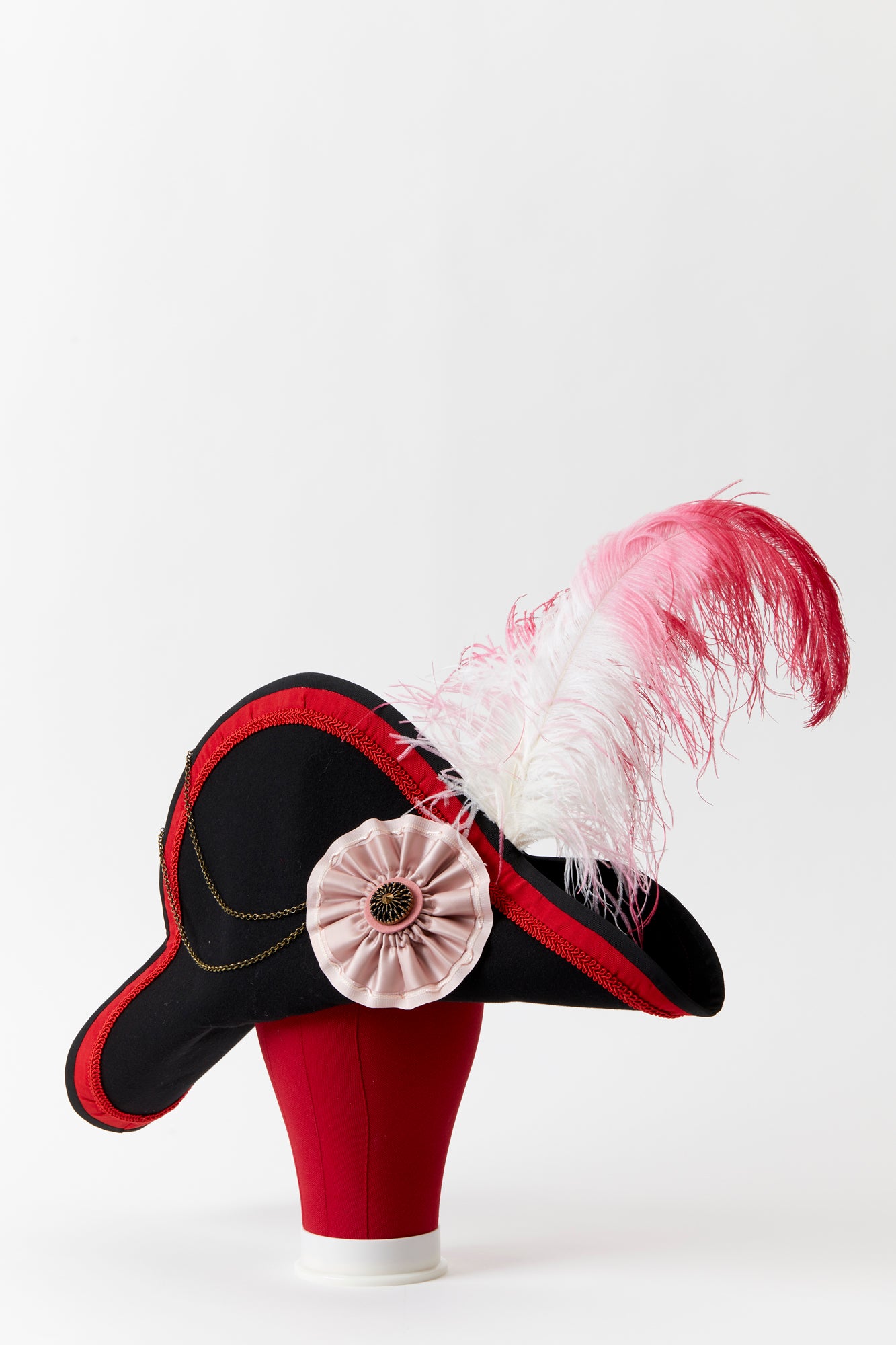  Napoleon’s iconic bicorn hat, ornamented with a silk rosette and a fanciful feather for flounce.