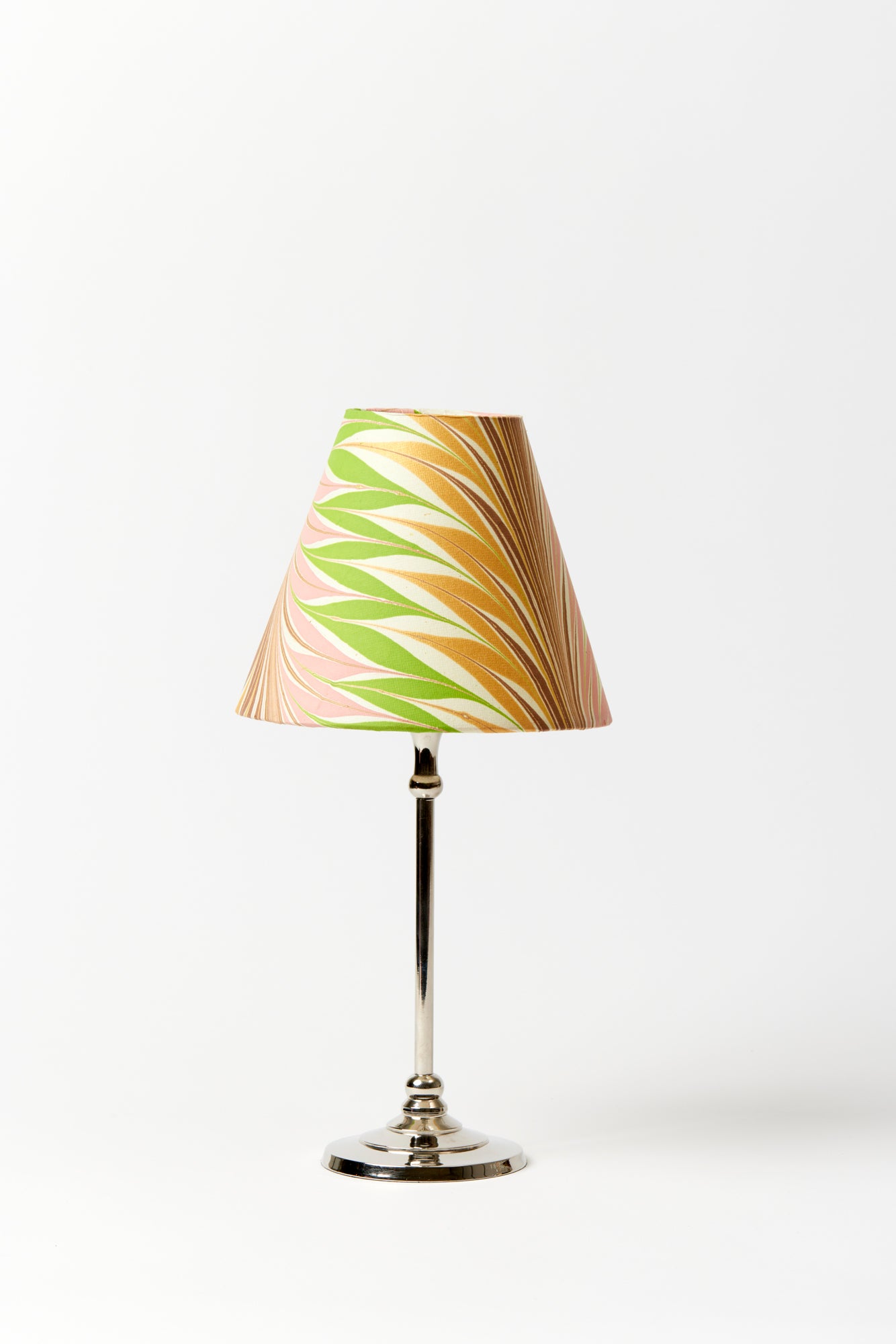 Marbled paper table lamp shade in desert palms.