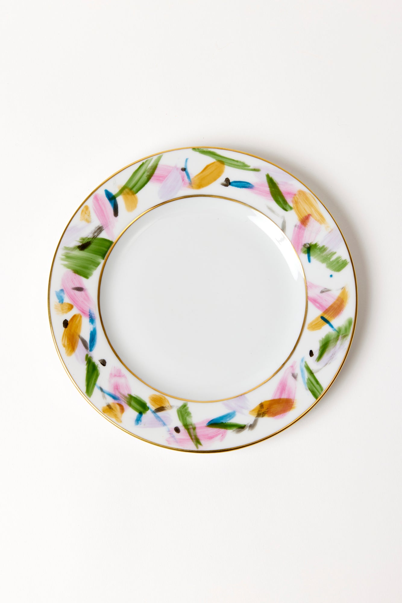 Hand-painted and traditionally crafted in an artisanal workshop in Arezzo, the spirited brushstrokes on this porcelain salad plate give a youthful twist to classic china.