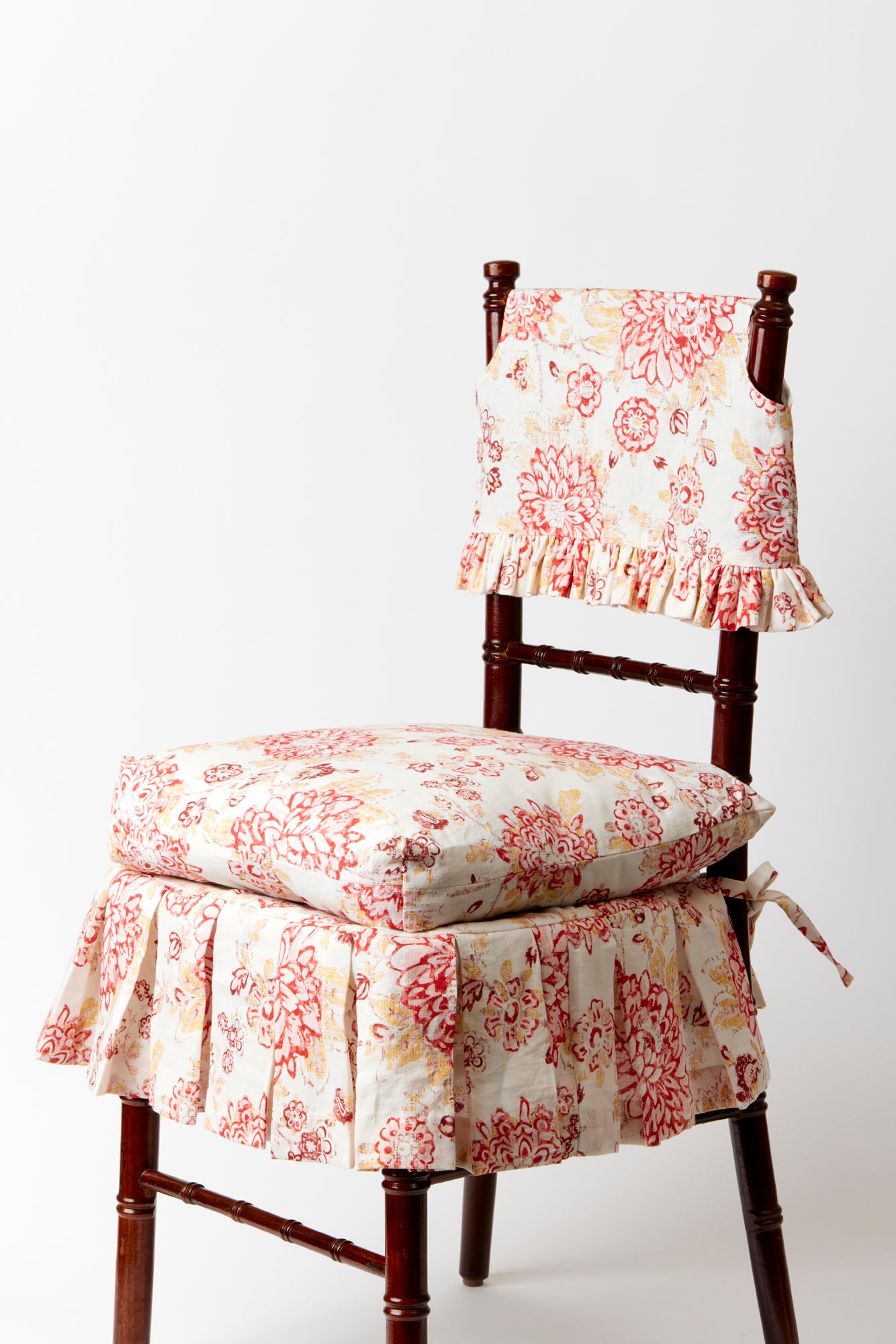 Ruffled slipcover and seat cushion in Spicy Floral hand-blocked linen fit a standard ballroom chair.