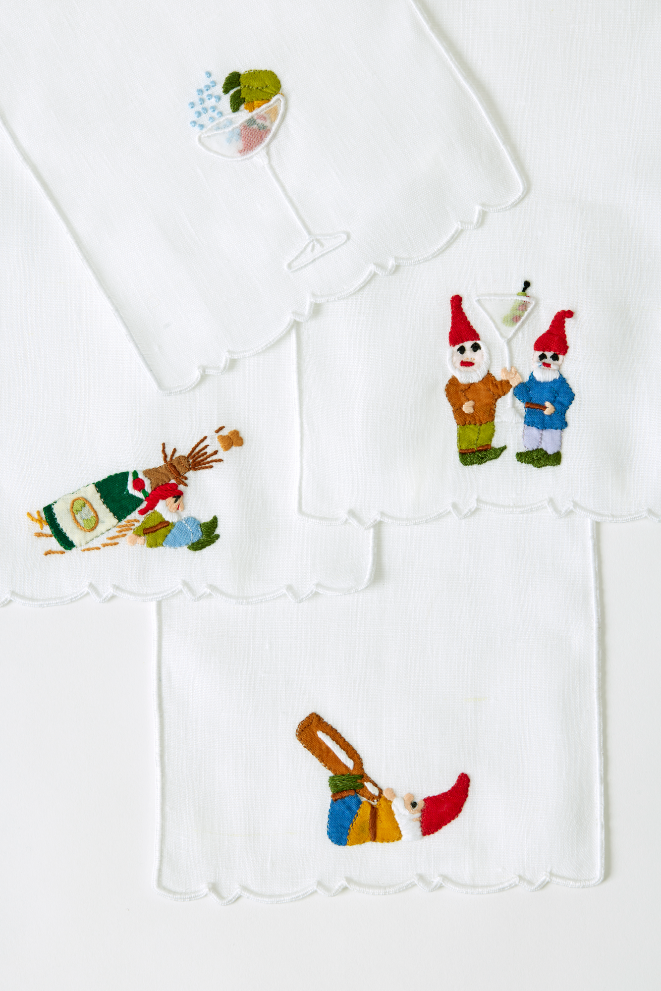 Set of four Gnome linen cocktail napkins made with hand embroidery and appliqué in Madeira, Portugal.