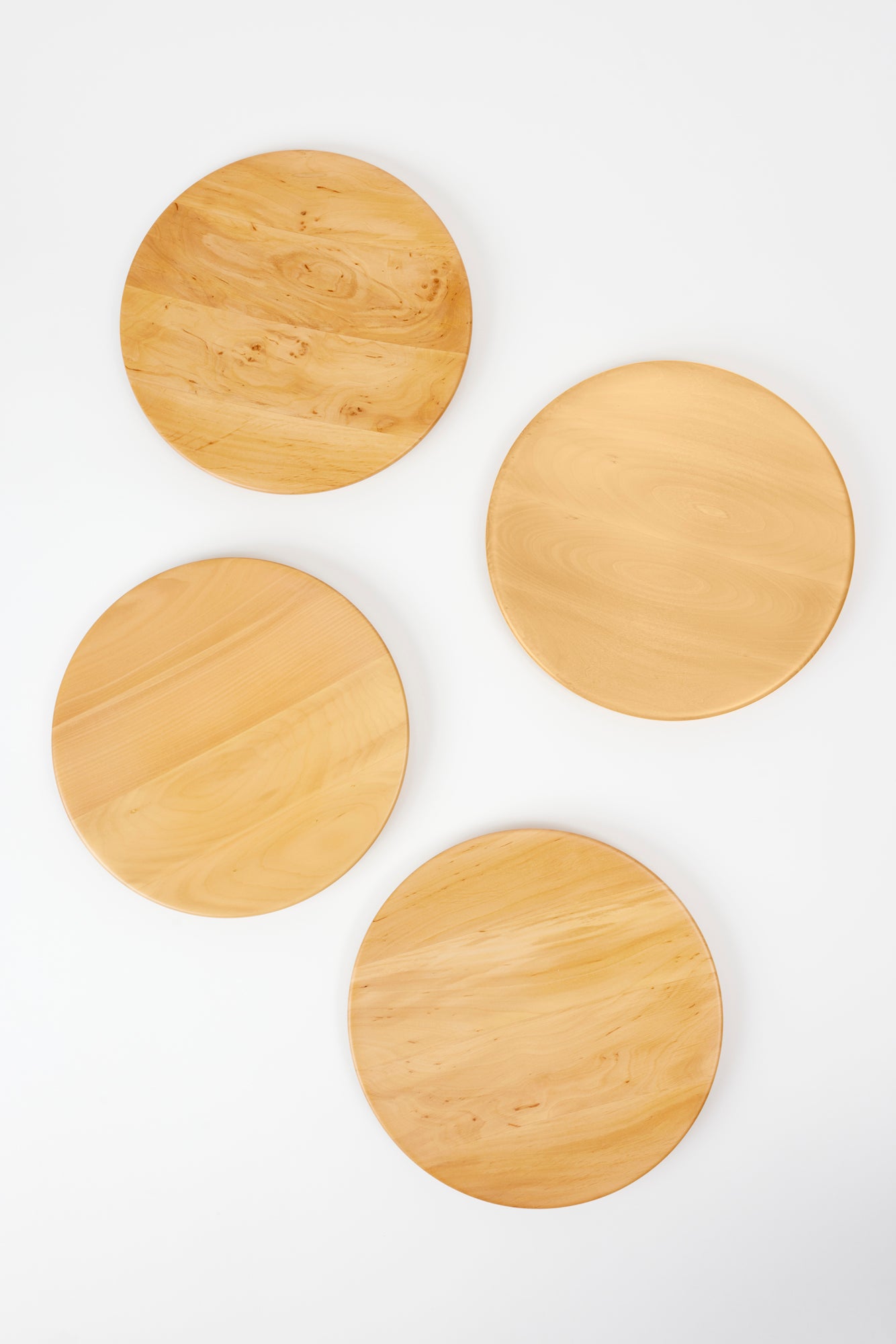 Set of four service plates designed for use as underplates or to serve dishes.