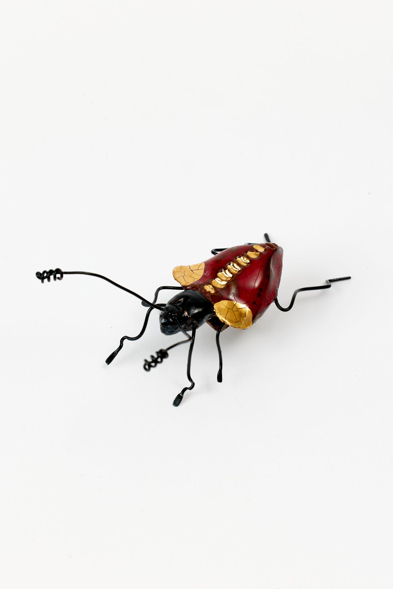 Handmade ceramic insects in various shapes, glazes, and guises.