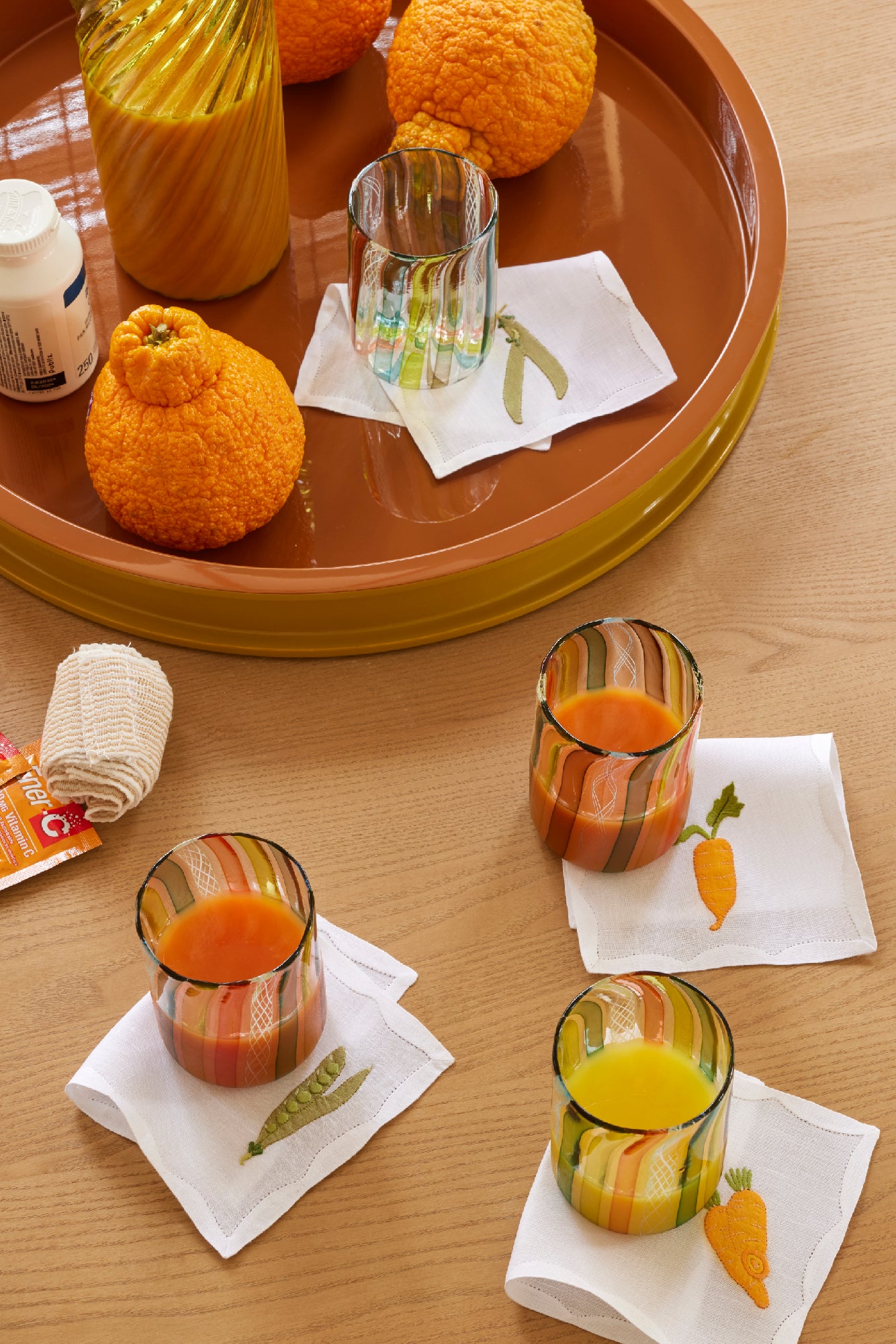 Cocktail napkins embroidered with peas and carrots.