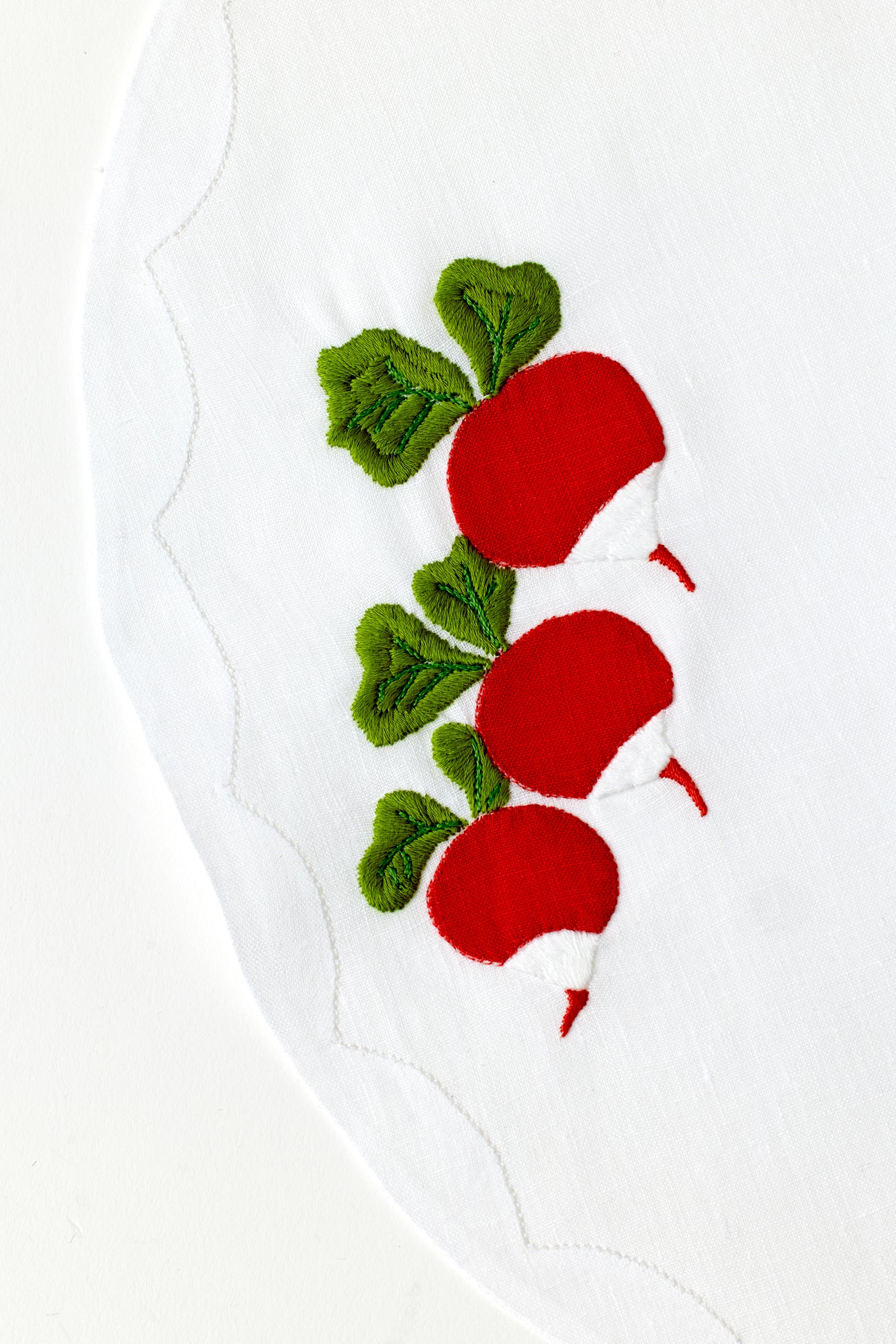 Embroidered radish on linen.