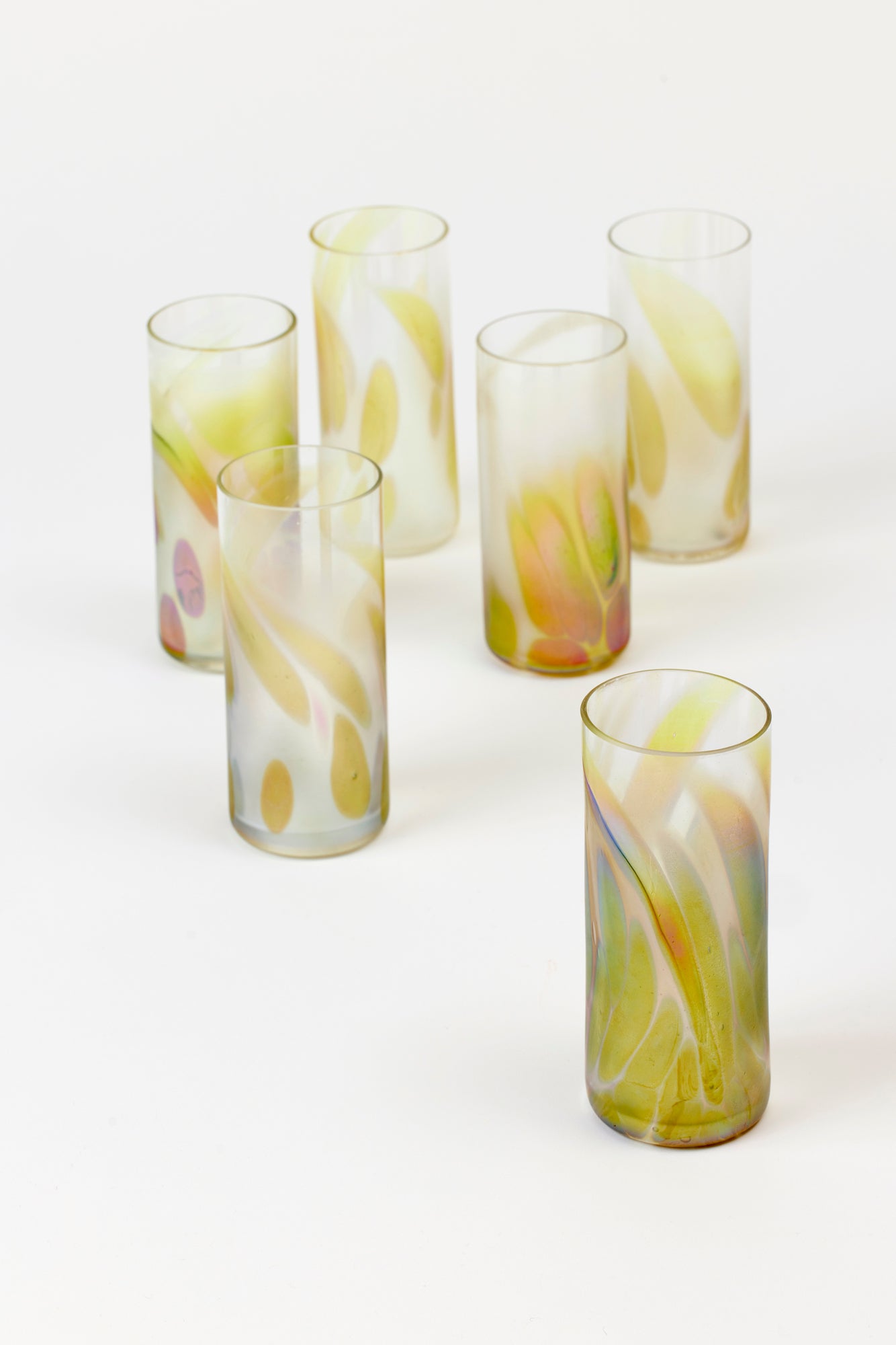 Iridescent tall glasses with purple and golden marks, perfect for Collins, spritzes, or everyday use. 