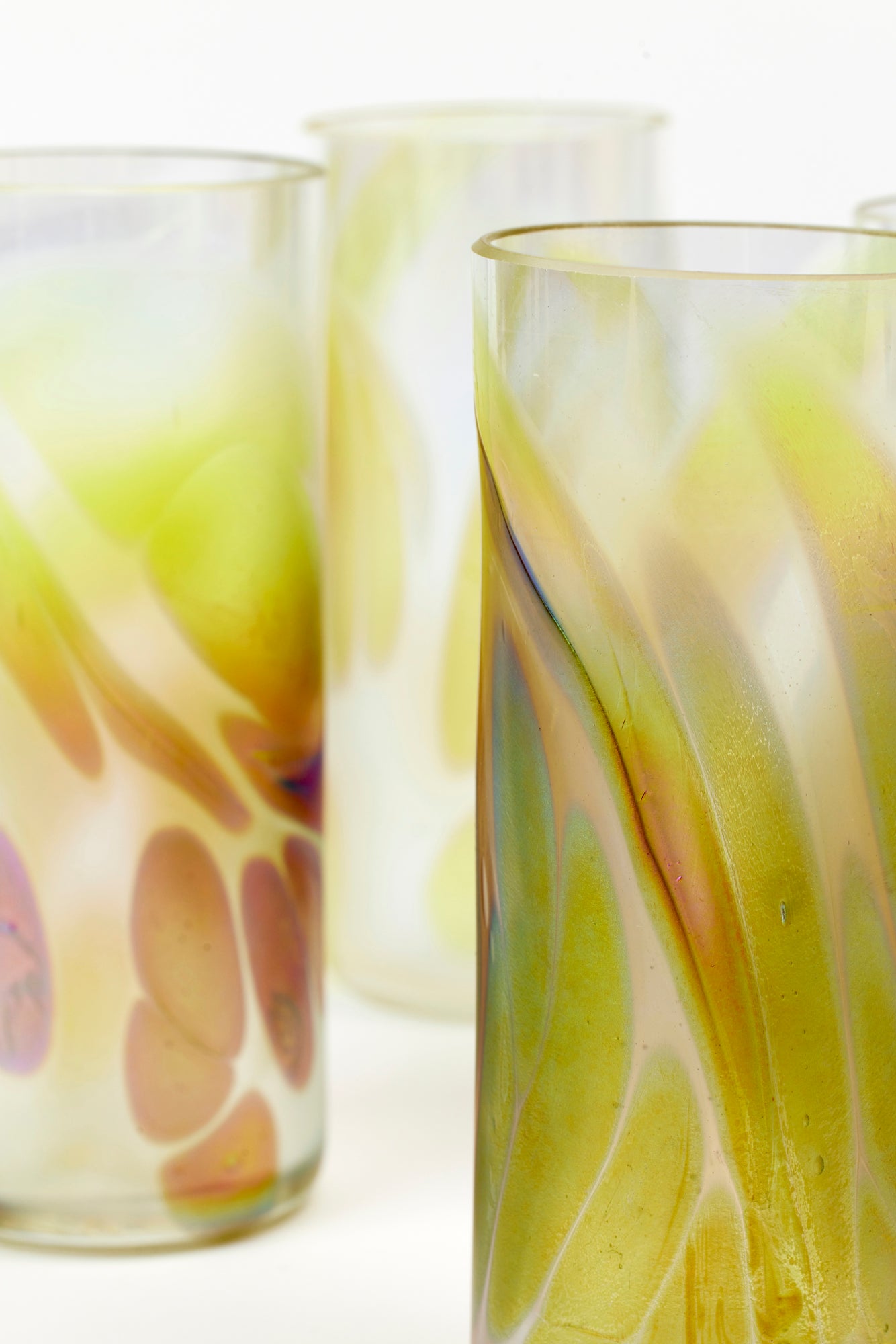 Tall iridescent glass tumblers with purple, gold and green.