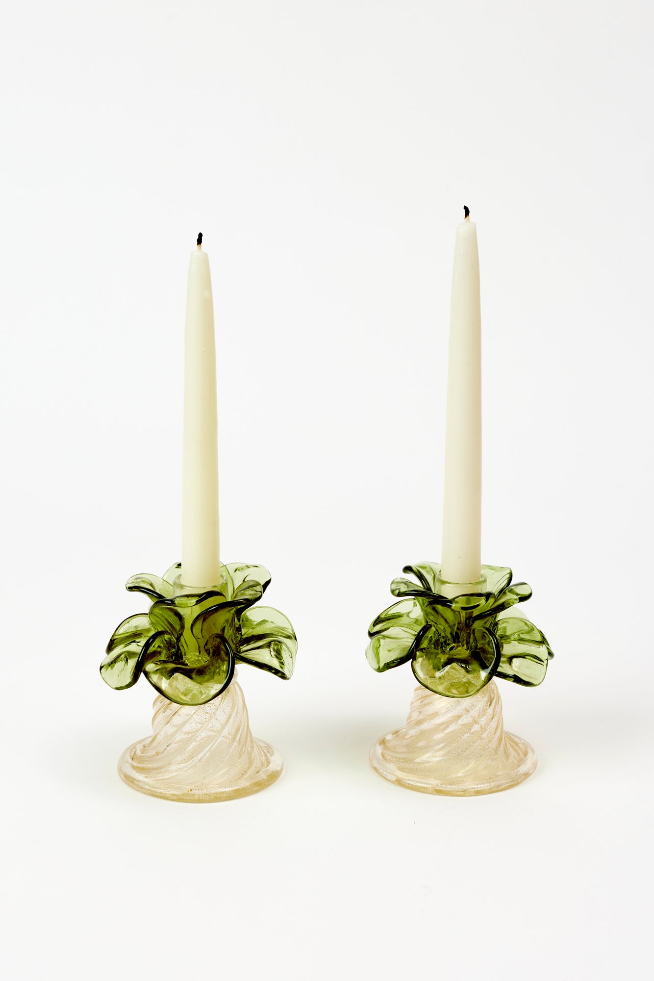 Green petals and clear, twisted glass with gold flecks. In excellent vintage condition.