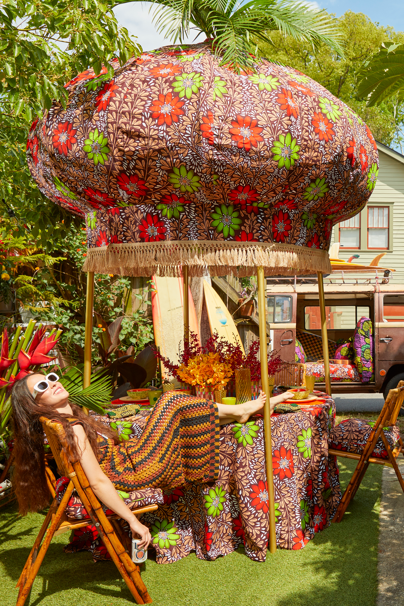 Onion canopy is upholstered with a removable Ankara cotton cover trimmed with jute fringe and finished with a functional vase finial for flamboyant plumes of ostrich feathers or showy palms.