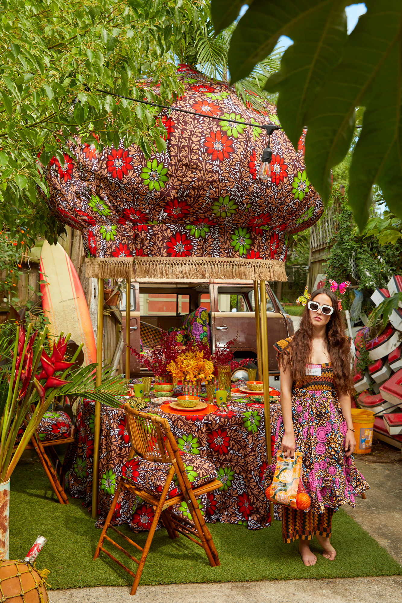 Onion canopy is upholstered with a removable Ankara cotton cover trimmed with jute fringe and finished with a functional vase finial for flamboyant plumes of ostrich feathers or showy palms.