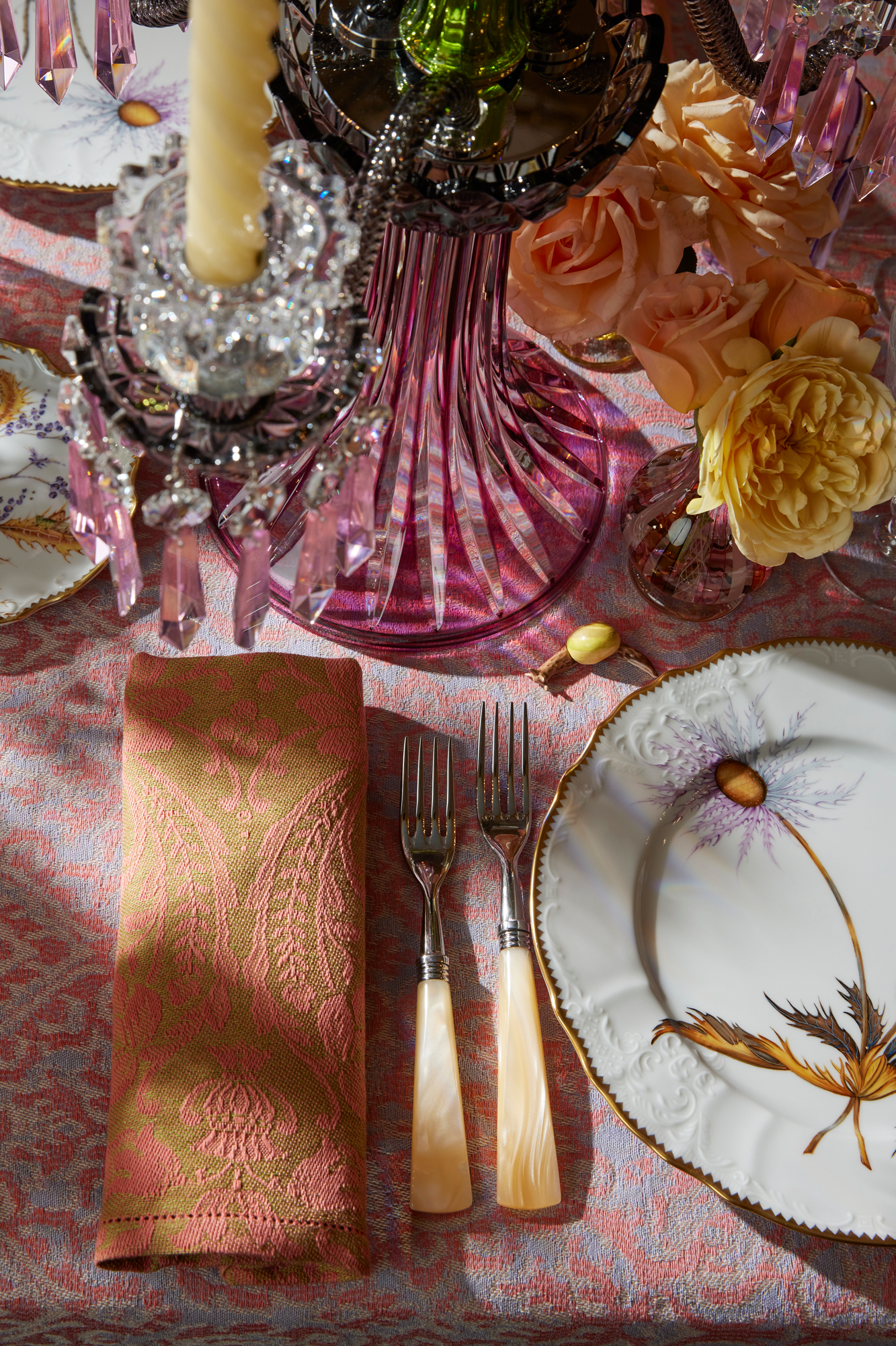 Fine porcelain plates, evocative of wild fairytale foliage from behind the castle wall.