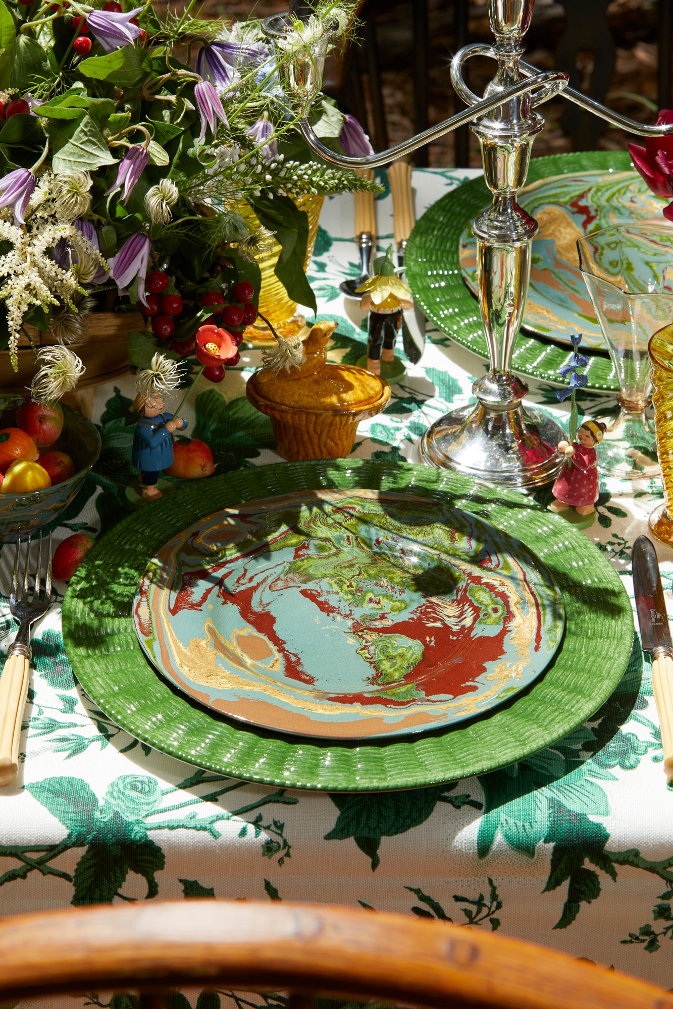 Green ceramic service plate trimmed in a wicker basket pattern.