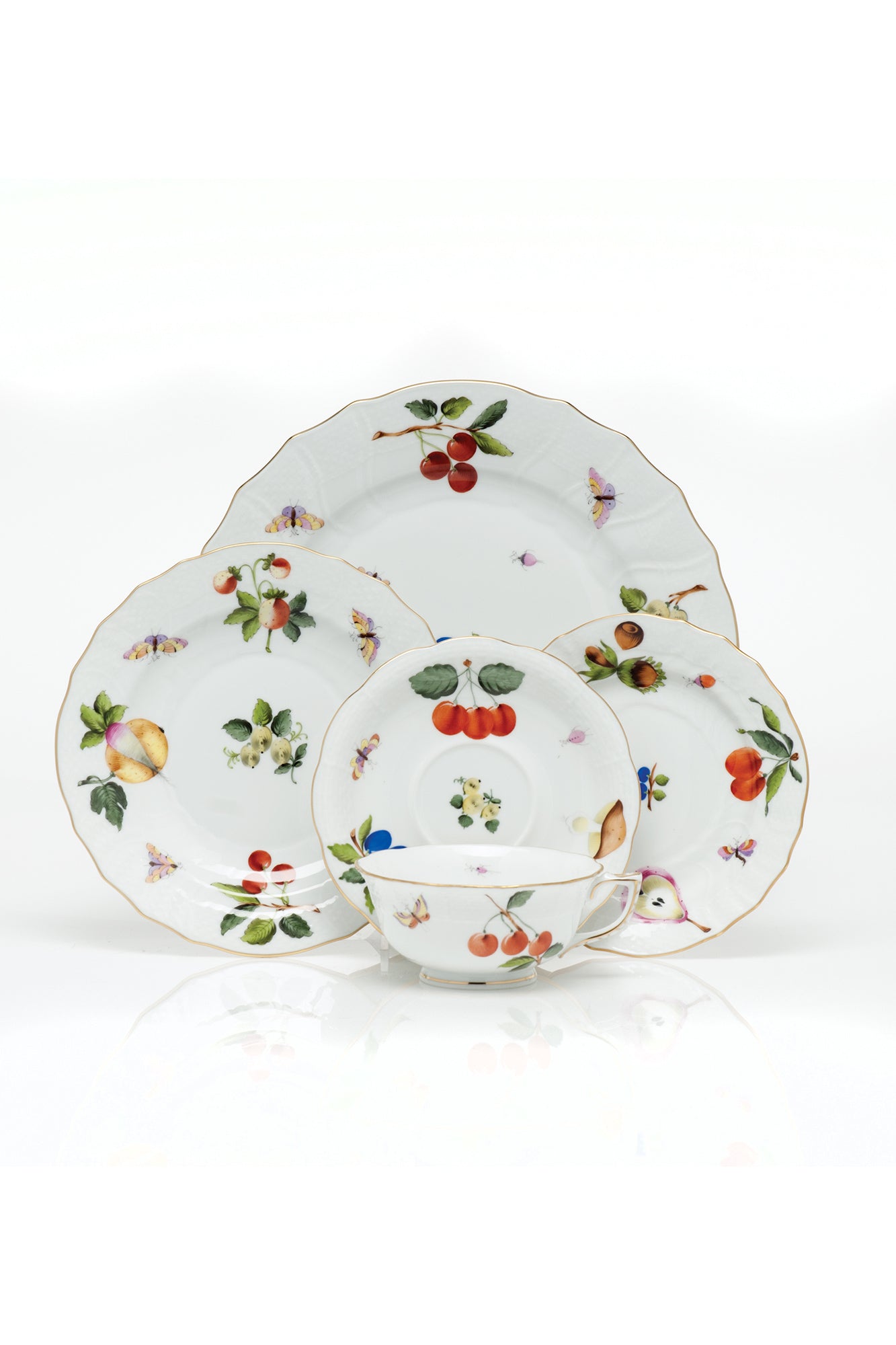 Market Garden designs on porcelain. Five piece place setting includes dinner plate, dessert plate, bread & butter plate and tea cup with saucer. 